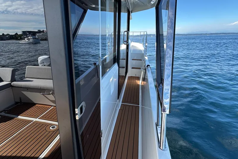 Fret Knot Yacht Photos Pics 2024 Beneteau Swift Trawler 41 Sedan on water, showcasing deck and seating area.