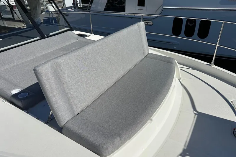 Fret Knot Yacht Photos Pics 2024 Beneteau Swift Trawler 41 Sedan with gray cushioned seating on deck.