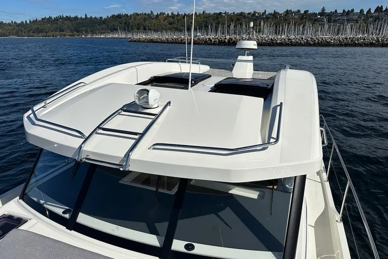 Fret Knot Yacht Photos Pics 2024 Beneteau Swift Trawler 41 Sedan on water, showcasing sleek design and rooftop features.