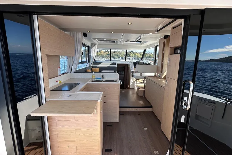 Fret Knot Yacht Photos Pics Interior of 2024 Beneteau Swift Trawler 41 Sedan with modern kitchen and ocean view.