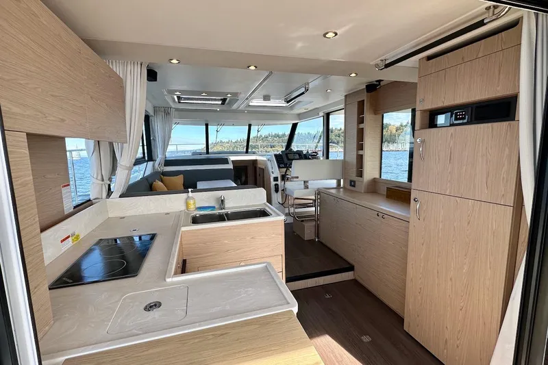 Fret Knot Yacht Photos Pics 2024 Beneteau Swift Trawler 41 Sedan interior with modern kitchen and panoramic windows.