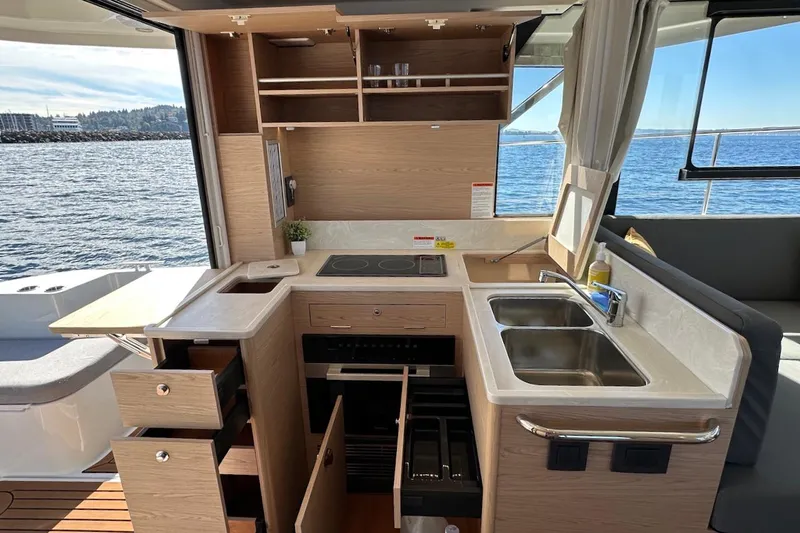 Fret Knot Yacht Photos Pics Modern kitchen interior of 2024 Beneteau Swift Trawler 41 Sedan with ocean view.
