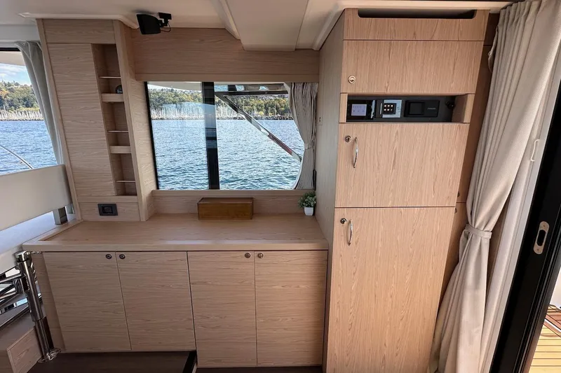 Fret Knot Yacht Photos Pics 2024 Beneteau Swift Trawler 41 Sedan interior with wood cabinetry and scenic window view.