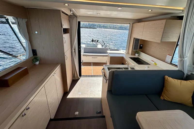 Fret Knot Yacht Photos Pics 2024 Beneteau Swift Trawler 41 Sedan interior with modern kitchen and seating, overlooking water.
