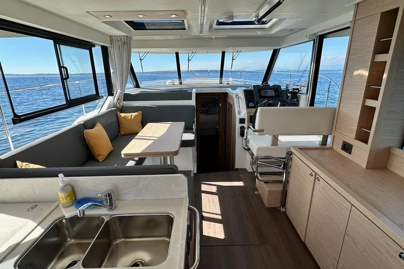 Fret Knot Yacht Photos Pics Interior of 2024 Beneteau Swift Trawler 41 Sedan with modern seating and ocean view.