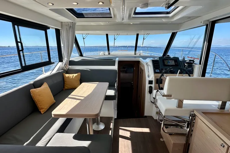 Fret Knot Yacht Photos Pics Interior of 2024 Beneteau Swift Trawler 41 Sedan with modern seating and navigation area.