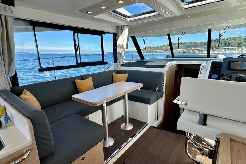 Fret Knot Yacht Photos Pics Interior of 2024 Beneteau Swift Trawler 41 Sedan with ocean view and modern seating.