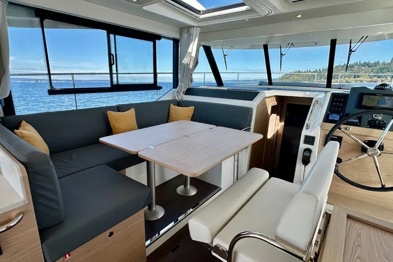 Fret Knot Yacht Photos Pics Interior of 2024 Beneteau Swift Trawler 41 Sedan with ocean view and modern seating.