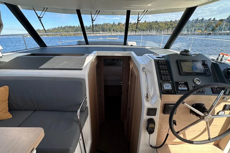 Fret Knot Yacht Photos Pics 2024 Beneteau Swift Trawler 41 Sedan helm with navigation equipment and scenic water view.