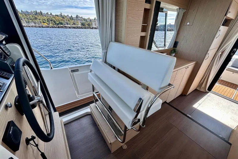 Fret Knot Yacht Photos Pics 2024 Beneteau Swift Trawler 41 Sedan interior with helm, seating, and scenic water view.