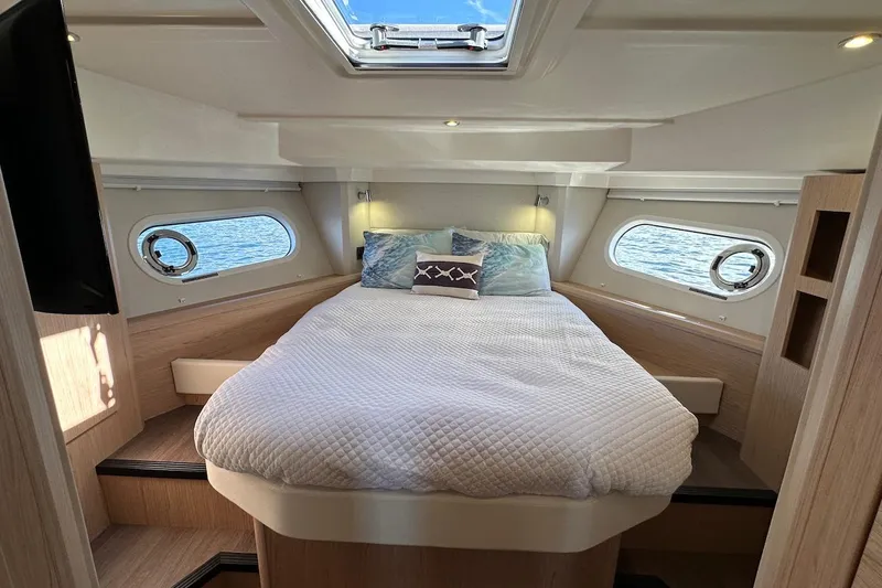 Fret Knot Yacht Photos Pics Luxurious cabin interior of 2024 Beneteau Swift Trawler 41 Sedan with cozy bedding.