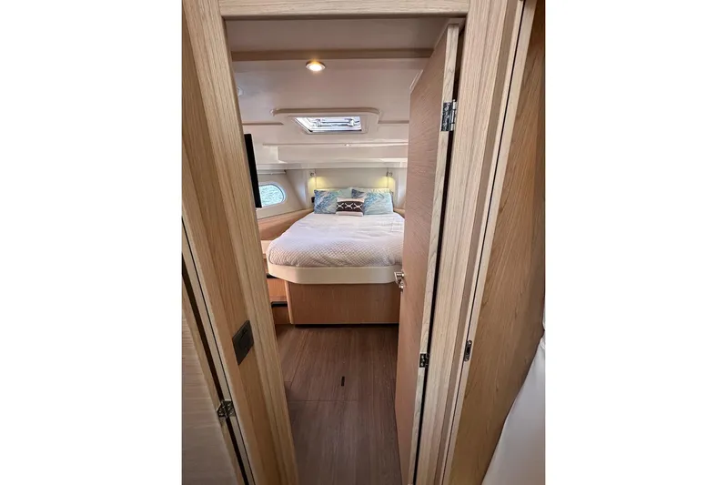Fret Knot Yacht Photos Pics 2024 Beneteau Swift Trawler 41 Sedan cabin interior with cozy bed and wooden finish.