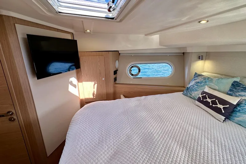 Fret Knot Yacht Photos Pics Luxurious bedroom interior of 2024 Beneteau Swift Trawler 41 Sedan with ocean view.