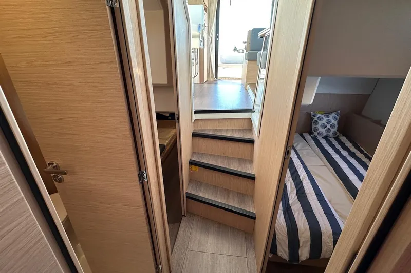 Fret Knot Yacht Photos Pics 2024 Beneteau Swift Trawler 41 Sedan interior with cozy cabin and striped bedding.