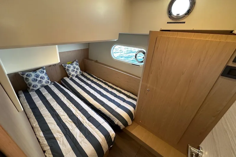Fret Knot Yacht Photos Pics 2024 Beneteau Swift Trawler 41 Sedan cabin with twin beds and nautical decor.