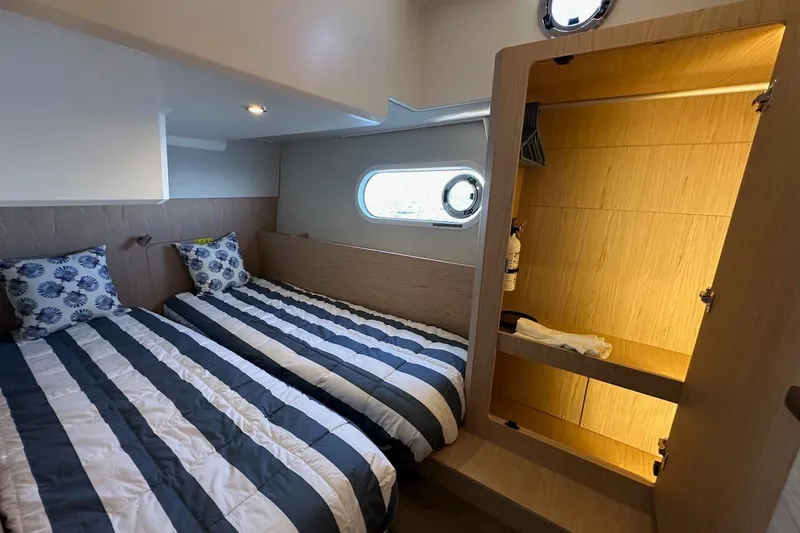 Fret Knot Yacht Photos Pics 2024 Beneteau Swift Trawler 41 Sedan cabin with twin beds and wooden closet.