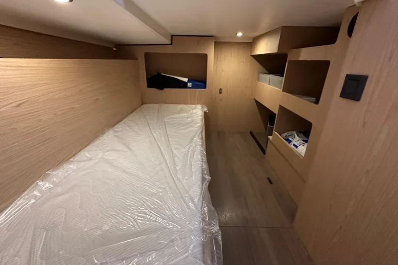 Fret Knot Yacht Photos Pics 2024 Beneteau Swift Trawler 41 Sedan cabin interior with wooden finish and storage shelves.