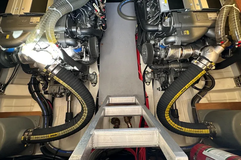 Fret Knot Yacht Photos Pics Engine room of 2024 Beneteau Swift Trawler 41 Sedan with dual engines and hoses.
