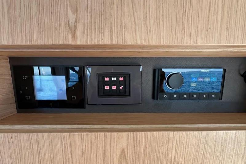 Fret Knot Yacht Photos Pics Control panel of 2024 Beneteau Swift Trawler 41 Sedan with touchscreen and audio system.
