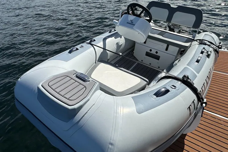 Fret Knot Yacht Photos Pics Inflatable boat docked on water, associated with 2024 Beneteau Swift Trawler 41 Sedan.