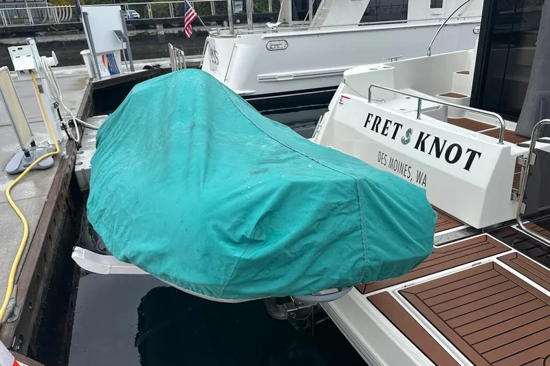 Fret Knot Yacht Photos Pics 2024 Beneteau Swift Trawler 41 Sedan docked, covered dinghy, Des Moines, WA.