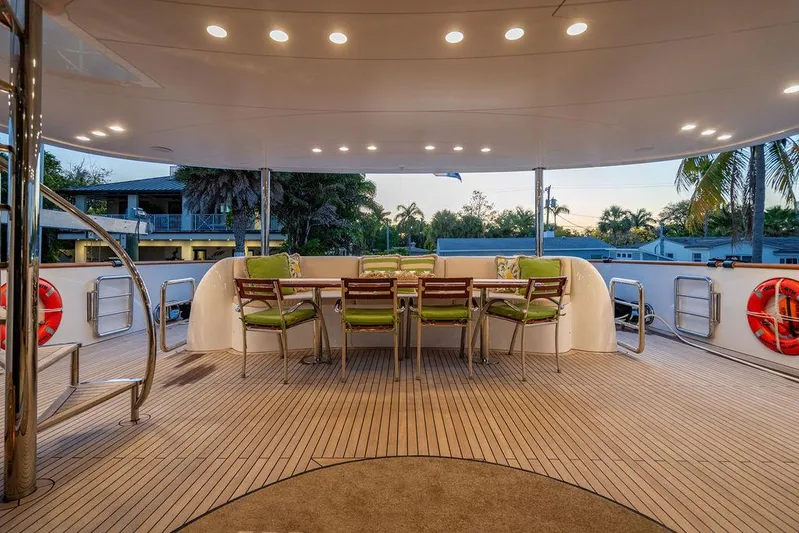 True North Yacht Photos Pics Luxurious 2011 Hargrave Tri Deck yacht with elegant outdoor dining area at sunset.