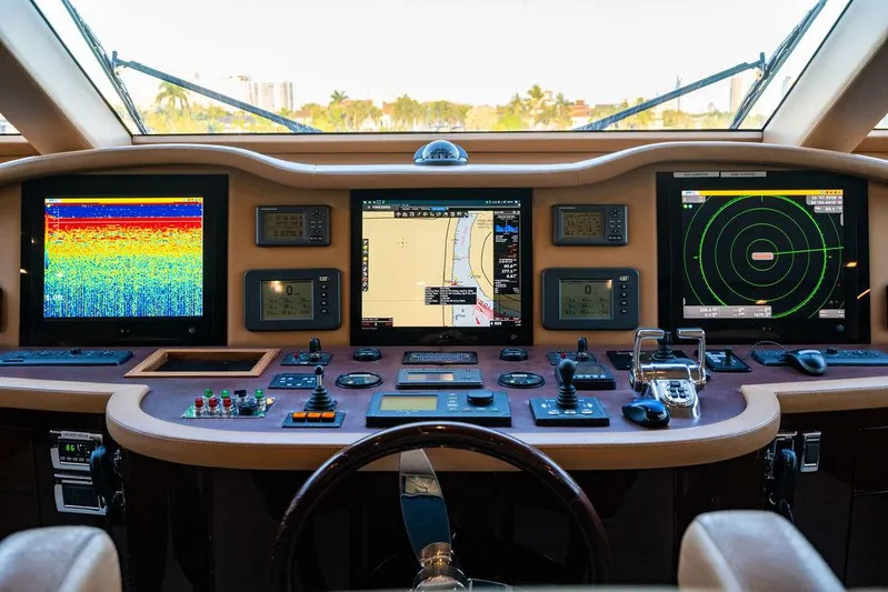 True North Yacht Photos Pics Control panel of a 2011 Hargrave Tri Deck yacht with navigation screens and instruments.