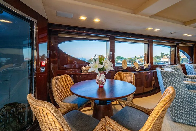 True North Yacht Photos Pics Luxurious interior of 2011 Hargrave Tri Deck yacht with elegant seating and floral centerpiece.