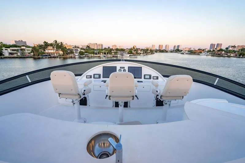 True North Yacht Photos Pics 2011 Hargrave Tri Deck yacht helm with three seats overlooking a scenic waterfront.