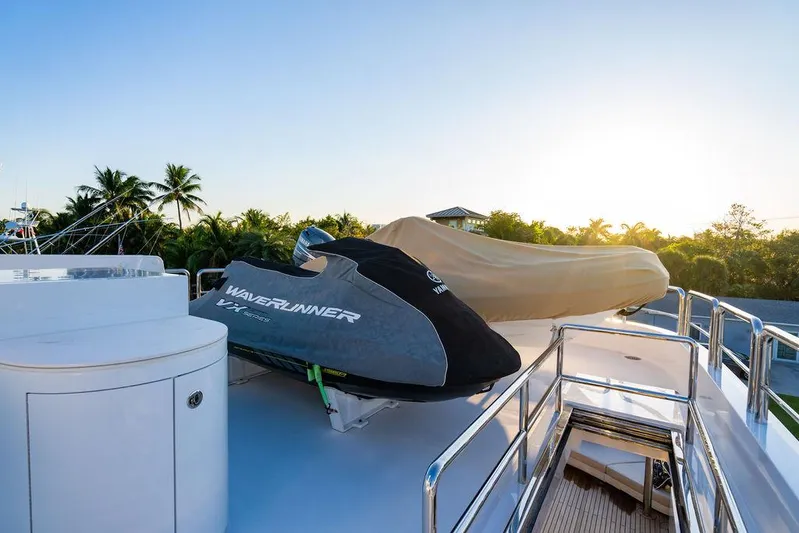 True North Yacht Photos Pics 2011 Hargrave Tri Deck yacht with jet skis on deck at sunset.