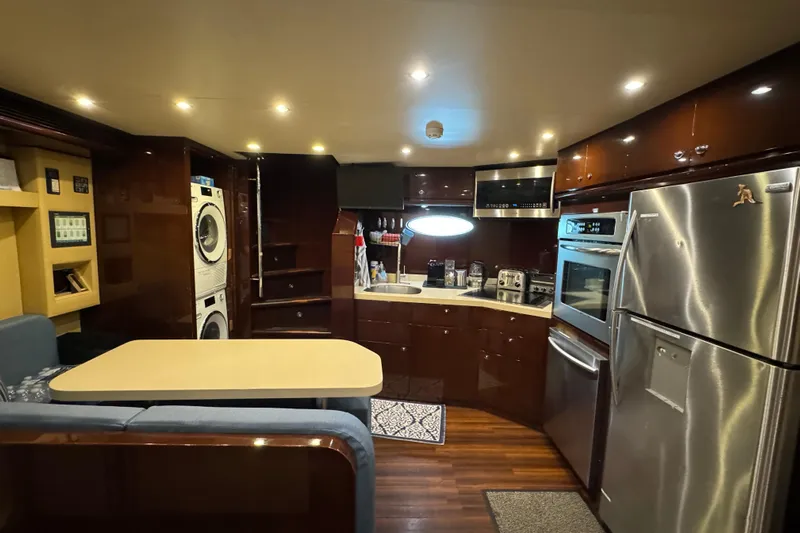 True North Yacht Photos Pics Luxurious 2011 Hargrave Tri Deck yacht kitchen with modern appliances and elegant wood finishes.