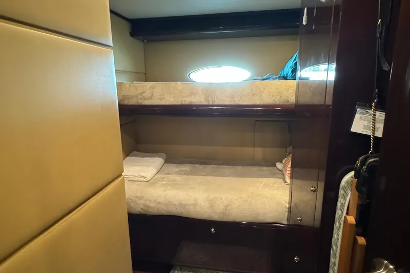 True North Yacht Photos Pics Bunk beds in 2011 Hargrave Tri Deck yacht cabin with porthole window.