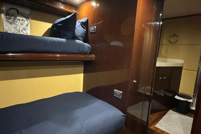 True North Yacht Photos Pics Bunk beds in 2011 Hargrave Tri Deck yacht cabin with dark wood finish.