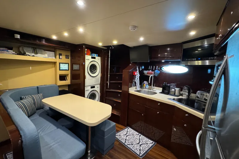 True North Yacht Photos Pics Luxurious 2011 Hargrave Tri Deck yacht interior with kitchen, dining area, and modern appliances.