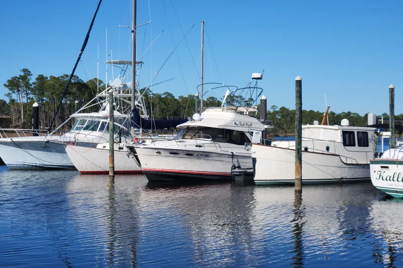  Yacht Photos Pics Boats docked at a marina, featuring a 2021 Cutwater C-32 CB under clear blue skies.