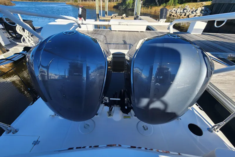  Yacht Photos Pics 2021 Cutwater C-32 CB boat with dual outboard engines docked by the water.