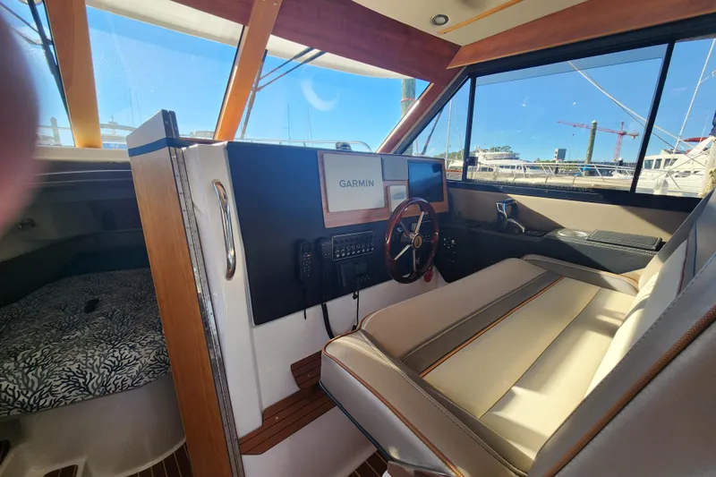  Yacht Photos Pics 2021 Cutwater C-32 CB boat interior with Garmin navigation system and steering wheel.