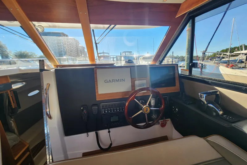  Yacht Photos Pics 2021 Cutwater C-32 CB helm with Garmin navigation, docked at marina.