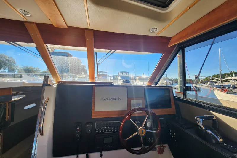  Yacht Photos Pics Interior view of 2021 Cutwater C-32 CB boat cockpit with Garmin navigation system.