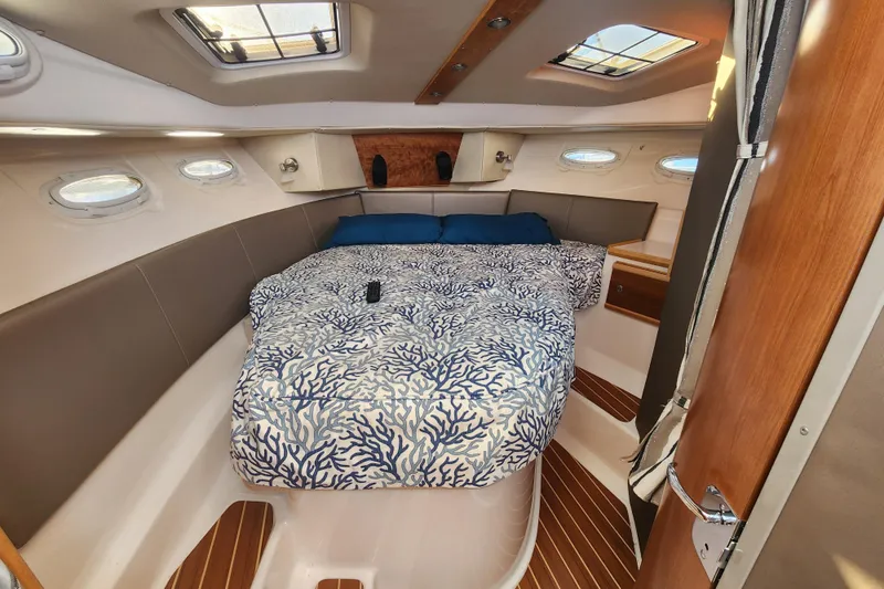  Yacht Photos Pics 2021 Cutwater C-32 CB cabin interior with bed, skylights, and wood accents.