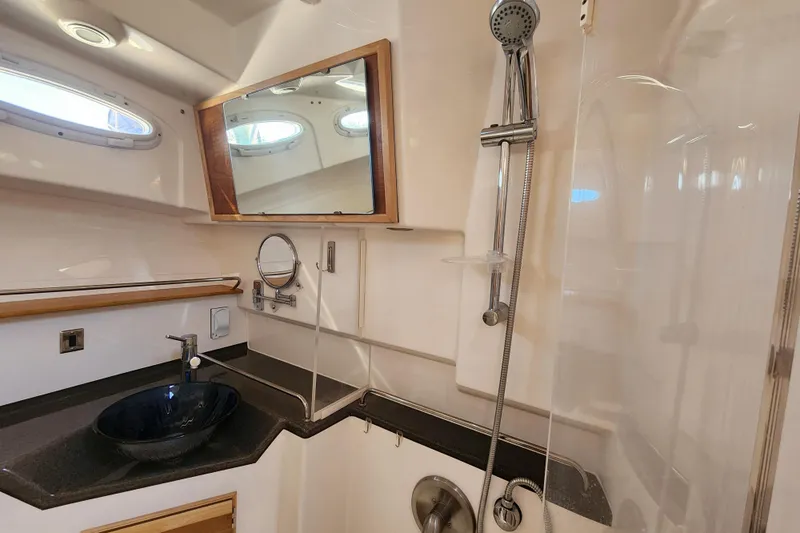  Yacht Photos Pics 2021 Cutwater C-32 CB yacht bathroom with modern sink, shower, and mirror.