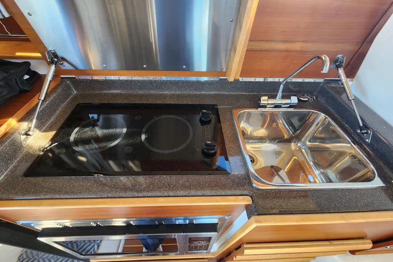  Yacht Photos Pics 2021 Cutwater C-32 CB kitchen with stove and dual sink setup.
