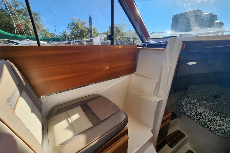  Yacht Photos Pics 2021 Cutwater C-32 CB interior with seating and cabin view, featuring wood accents.