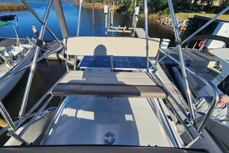  Yacht Photos Pics 2021 Cutwater C-32 CB boat at dock, featuring upper deck seating and stainless steel railings.