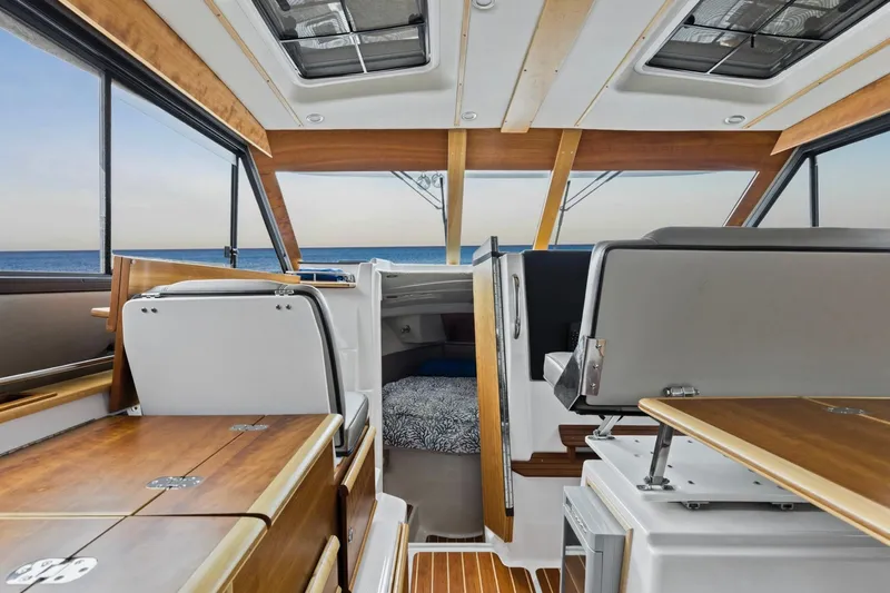  Yacht Photos Pics Interior of 2021 Cutwater C-32 CB boat with wood accents and ocean view.