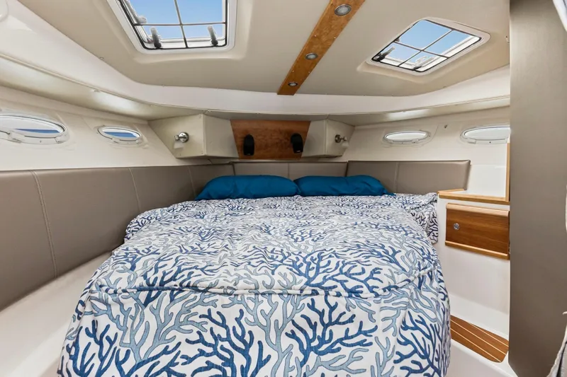  Yacht Photos Pics 2021 Cutwater C-32 CB cabin interior with bed and nautical decor.