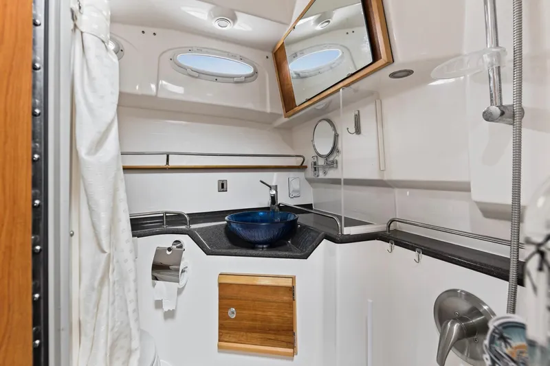  Yacht Photos Pics 2021 Cutwater C-32 CB boat bathroom with modern sink, mirror, and shower.