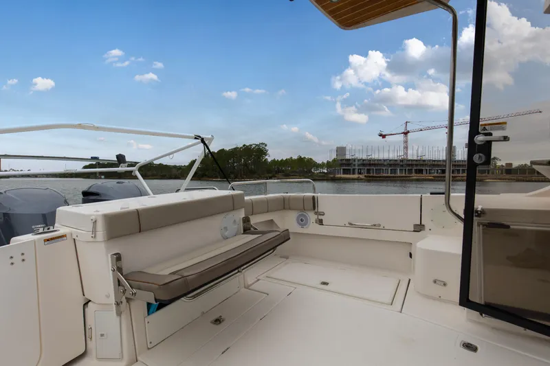 Yacht Photos Pics 2021 Cutwater C-32 CB boat interior with seating, overlooking waterfront construction.