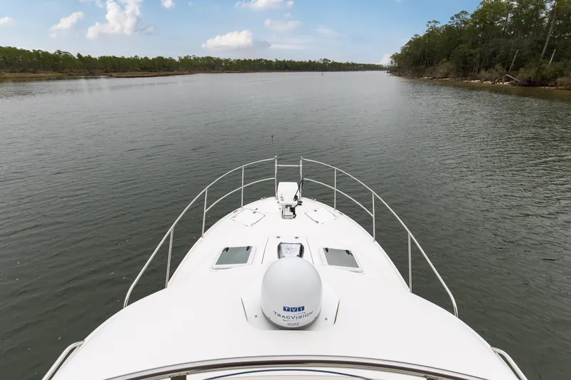  Yacht Photos Pics Bow view of 2021 Cutwater C-32 CB cruising on a serene river.