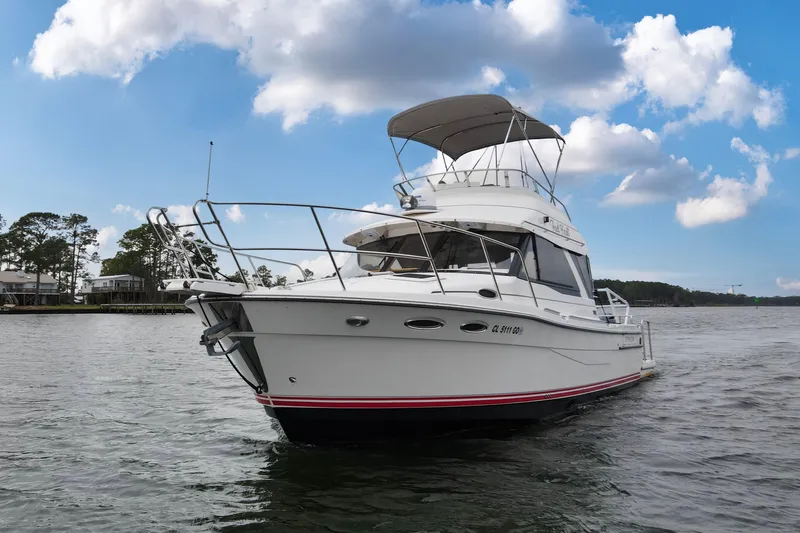  Yacht Photos Pics 2021 Cutwater C-32 CB boat on water under a partly cloudy sky.